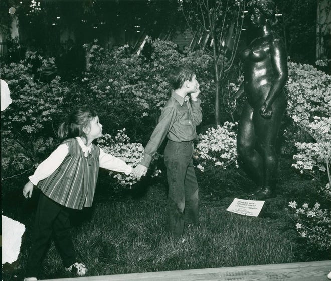A young boy seems scandalized by a sculpture at the 1956 Philadelphia Flower Show.