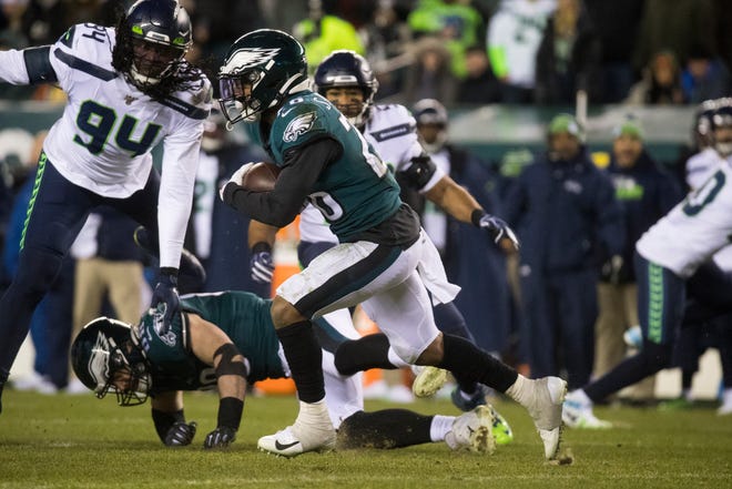 Eagles' Miles Sanders (26) rushes downfield Sunday against the Seahawks.