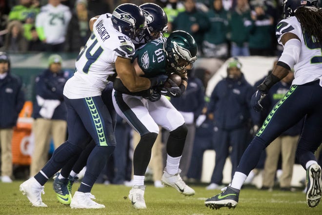 Eagles' Dallas Goedert (88) is wrapped up by the Seahawks defense Sunday at Lincoln Financial Field.
