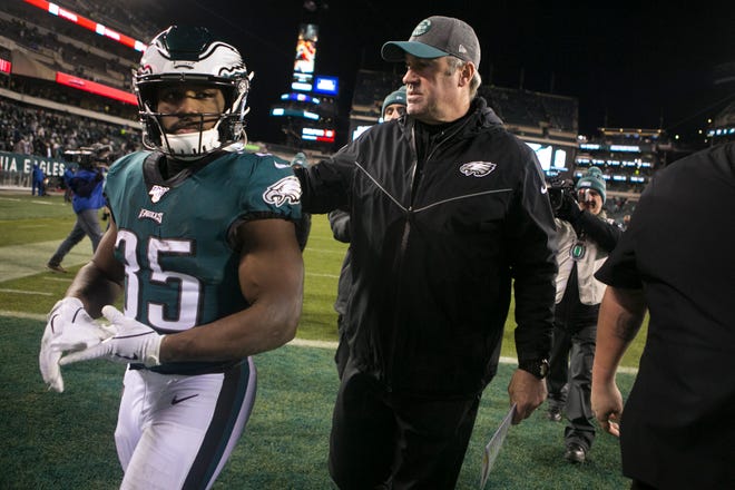 Eagles head coach Doug Pederson, right, puts his arm around running back Boston Scott (35) after losing to the Seattle Seahawks 17-9 Sunday night at Lincoln Financial Field.