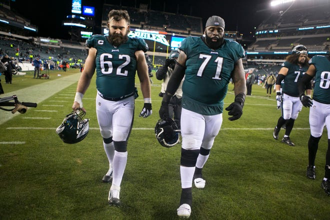 Philadelphia's Jason Kelce (62) and Jason Peters (71) hang their heads as they head towards the lock room tunnel after losing to the Seattle Seahawks 17-9 Sunday night at Lincoln Financial Field.
