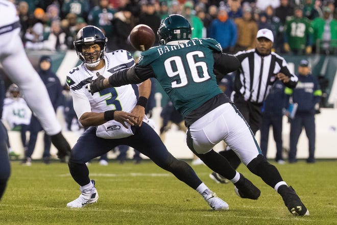 Seattle's Russell Wilson (3) throws the ball before Philadelphia's Derek Barnett (96) can get to him Sunday night at Lincoln Financial Field. The Seahawks defeated the Eagles ending their season 17-9.