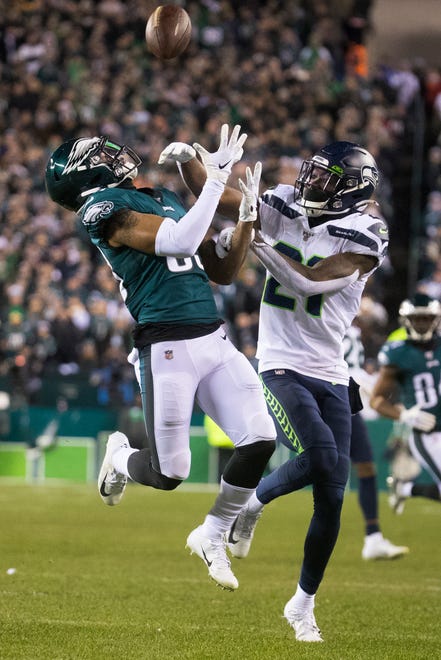 Eagles' Shelton Gibson watches a pass come in as he is fouled by Seattle's Tre Flowers (21) Sunday night at Lincoln Financial Field. The Seahawks defeated the Eagles ending their season 17-9.