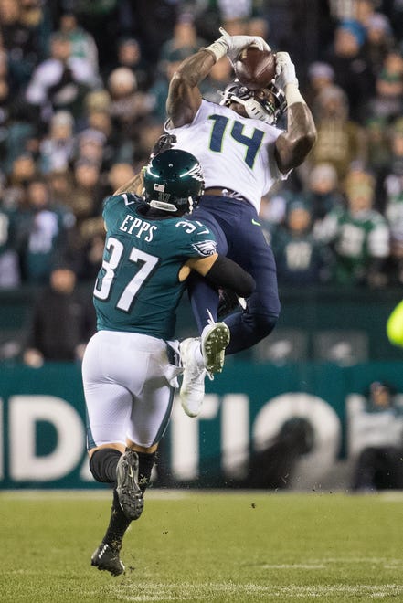 Seattle's DK Metcalf (14) makes a jumping catch over Philadelphia's Marcus Epps (37).