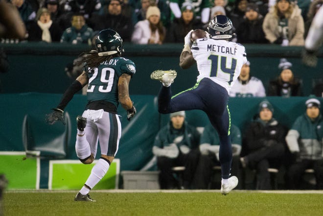 Seattle's DK Metcalf (14) makes a deep catch ahead of Philadelphia's Avonte Maddox (29) and would go on to score Sunday night at Lincoln Financial Field. The Seahawks defeated the Eagles ending their season 17-9.