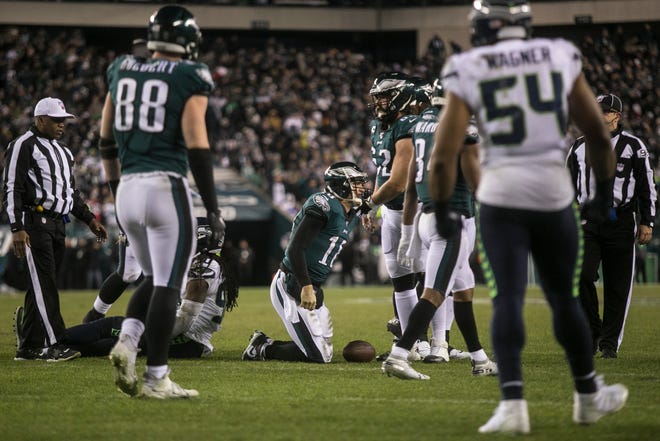 Eagles' Josh McCown (18) gets up after being sacked on fourth down towards the end of the game Sunday night against the Seahawks. The Seahawks defeated the Eagles ending their season 17-9.