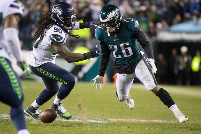 Eagles' Miles Sanders (26) looks down at a dropped pass on fourth down Sunday night at Lincoln Financial Field. The Seahawks defeated the Eagles ending their season 17-9.