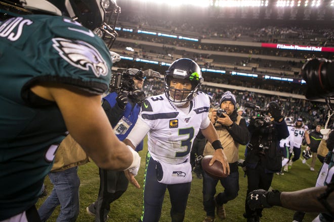 Seattle's Russell Wilson (3) shakes hands after defeating the Philadelphia Eagles in their NFC Wild Card playoff game Sunday night at Lincoln Financial Field. The Seahawks defeated the Eagles ending their season 17-9.