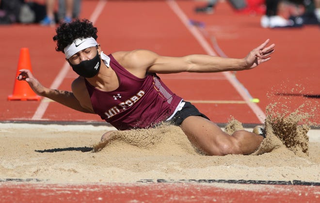 Milford's Emanuelle Carranza jumps en route to his first place finish in the long jump during the DIAA state indoor track and field championships at Dover High School Wednesday, March 3, 2021.